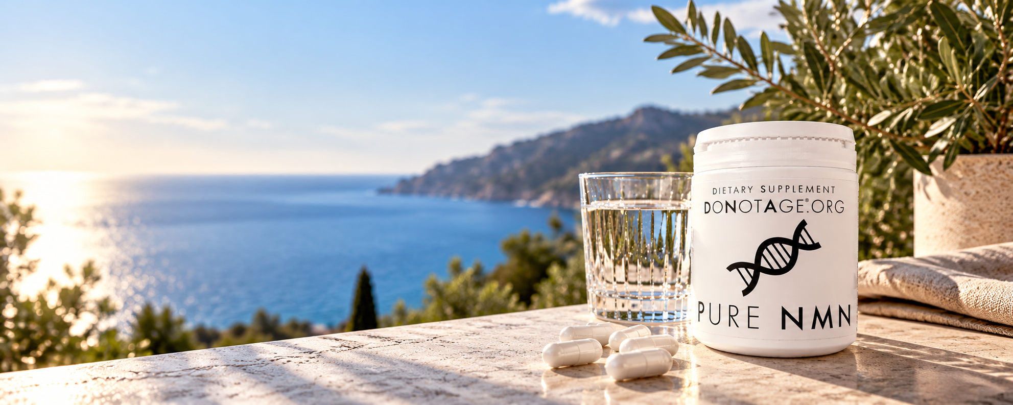 A tub of Pure NMN and a glass of water on a terrace above the sea at sunrise